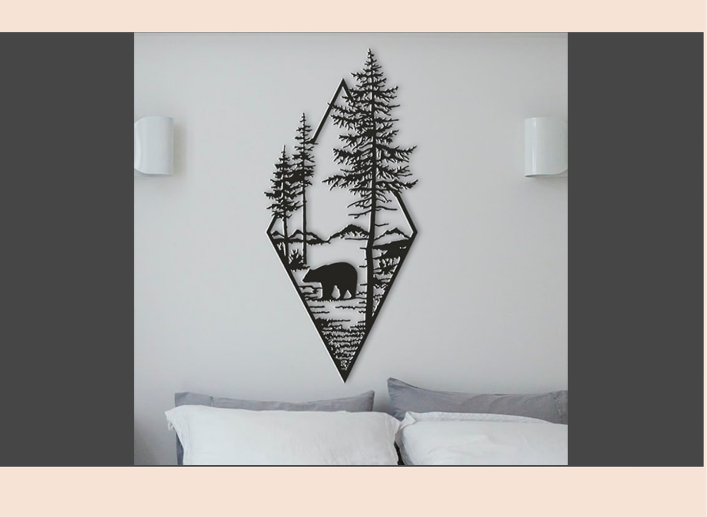 Geometric wall art with a bear and trees on a white wall above a bed.