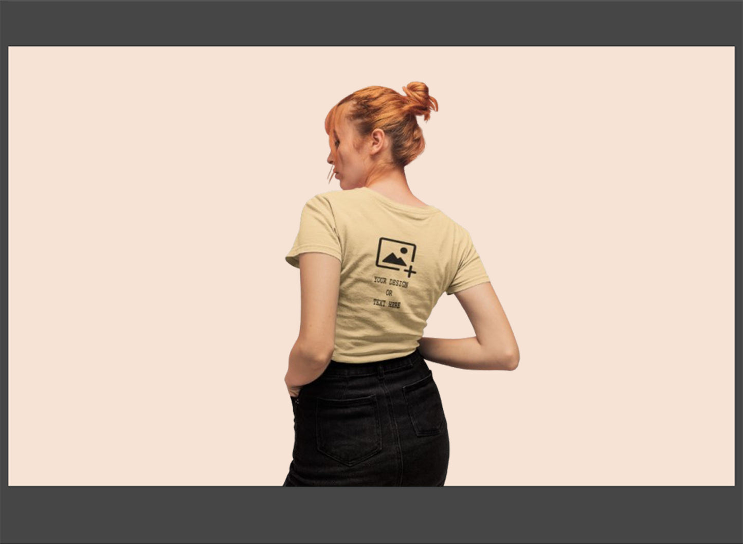 Person wearing a beige t-shirt with a logo on the back against a beige background