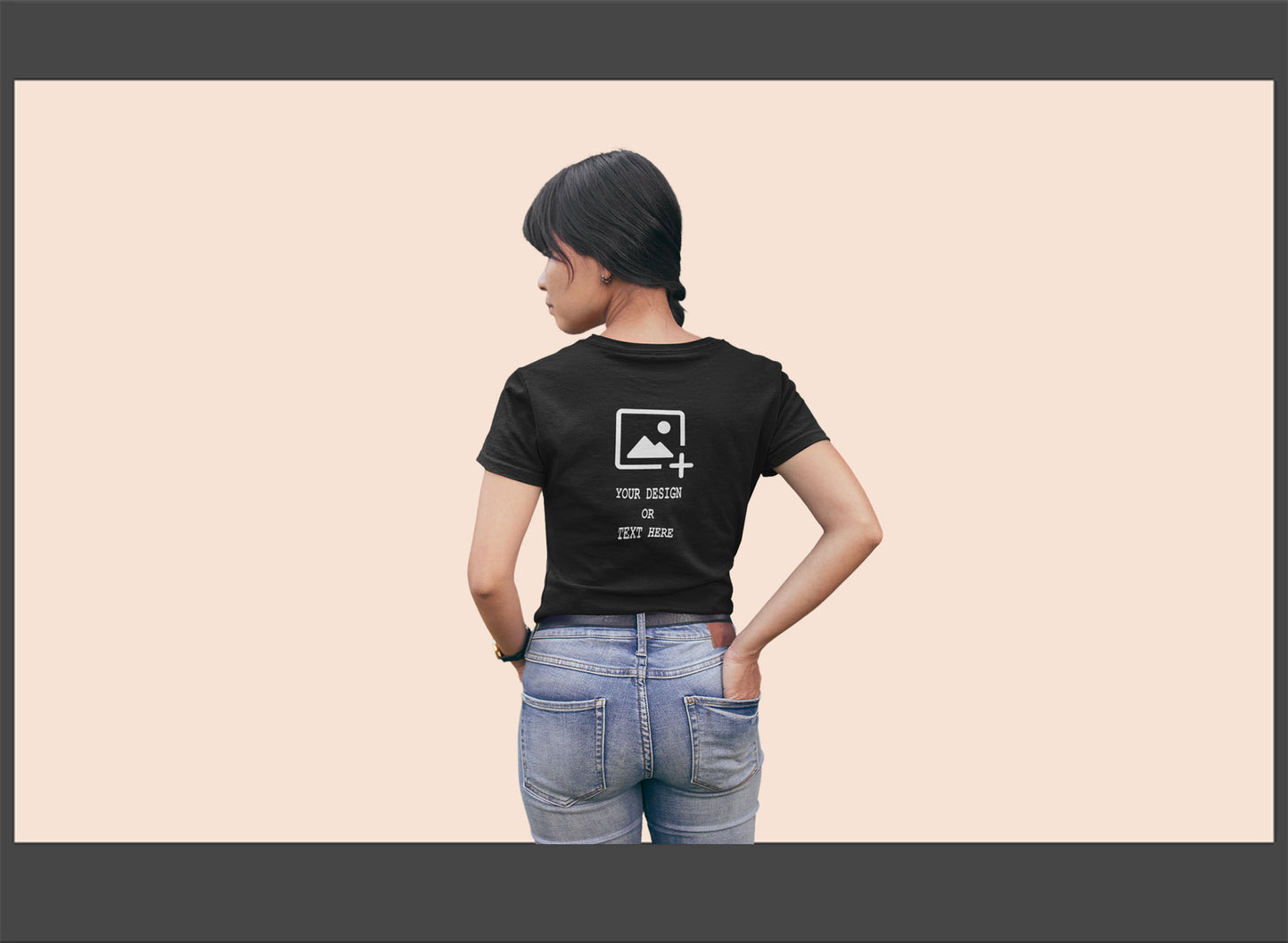 Person wearing a black t-shirt with a design on back.