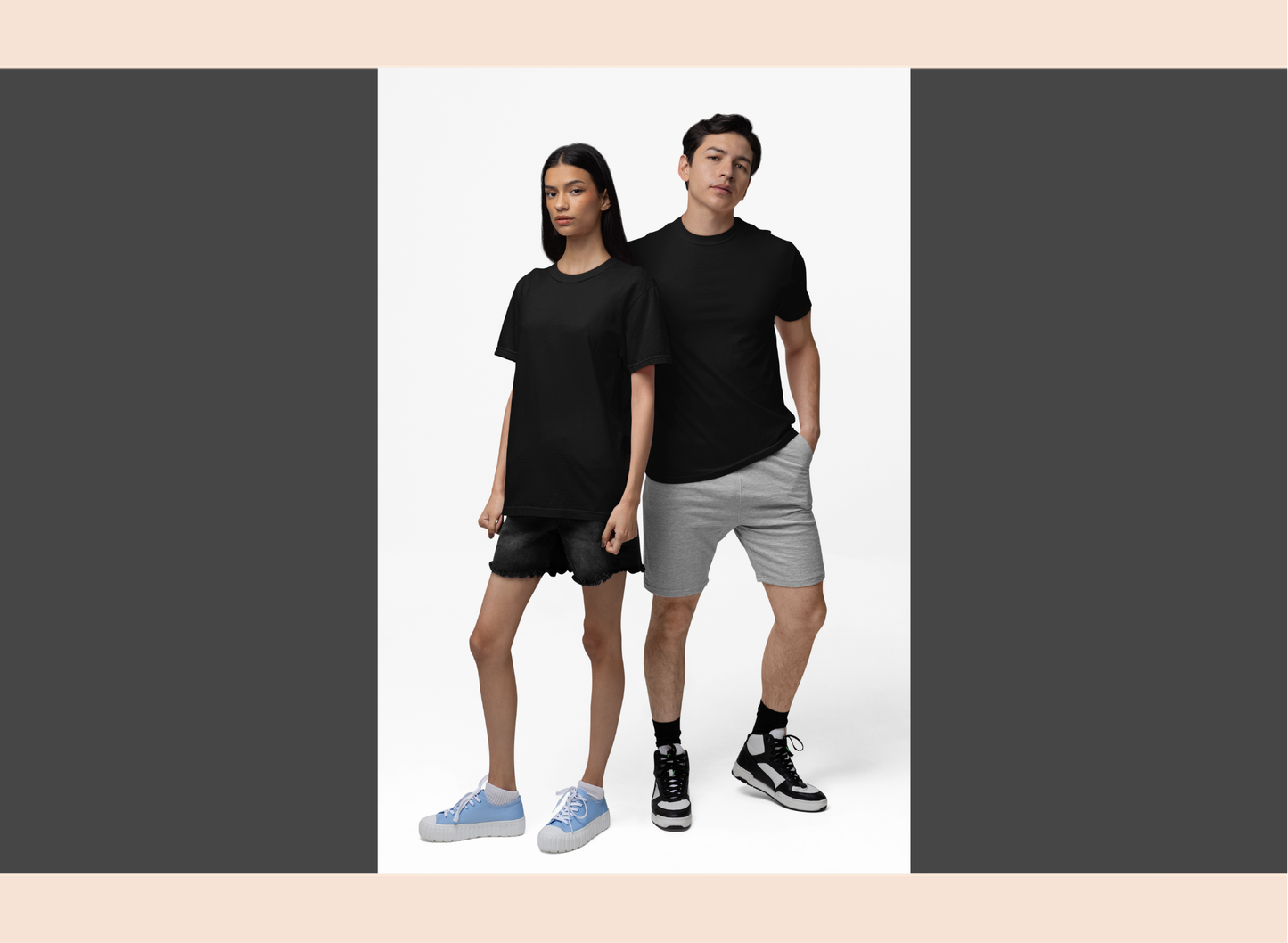 Two people wearing black t-shirts and gray shorts on a white background
