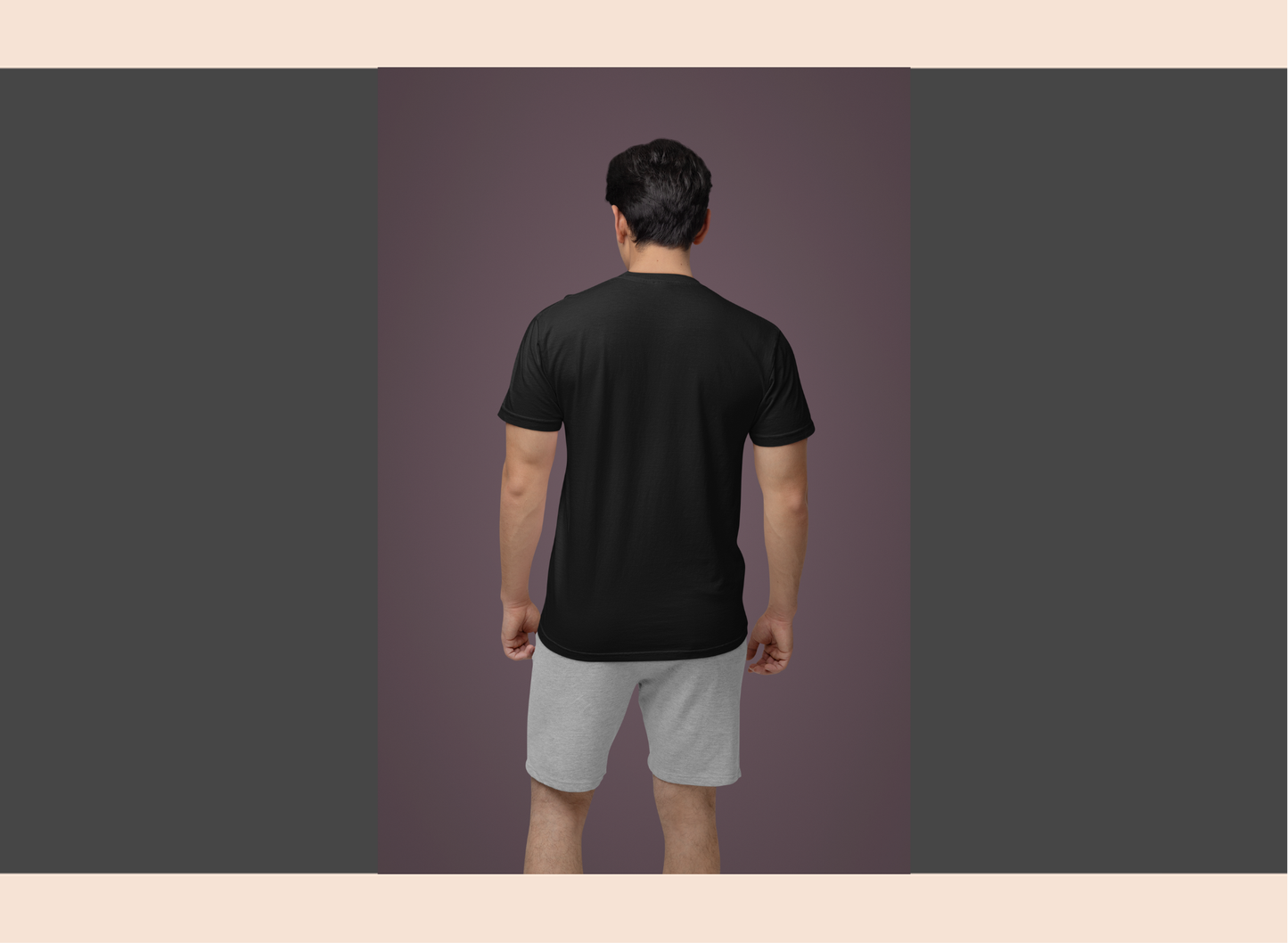 Person wearing a black t-shirt and gray shorts on a purple background
