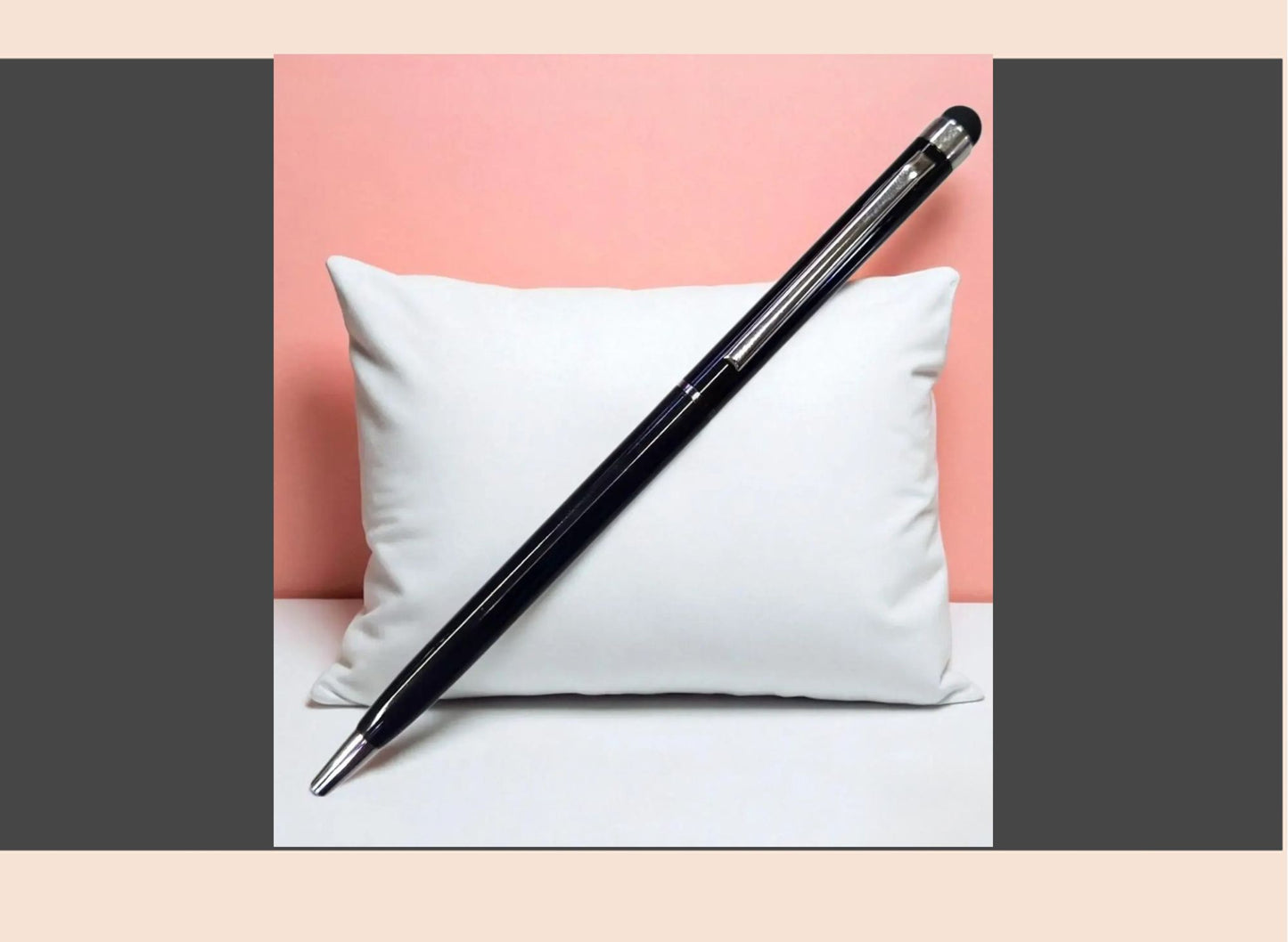 Black pen on a white pillow against a pink background