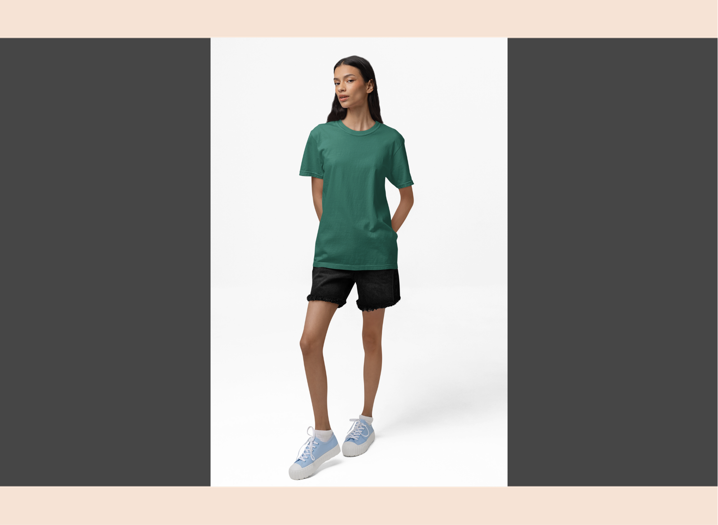 Woman wearing a green t-shirt and black shorts on a white background