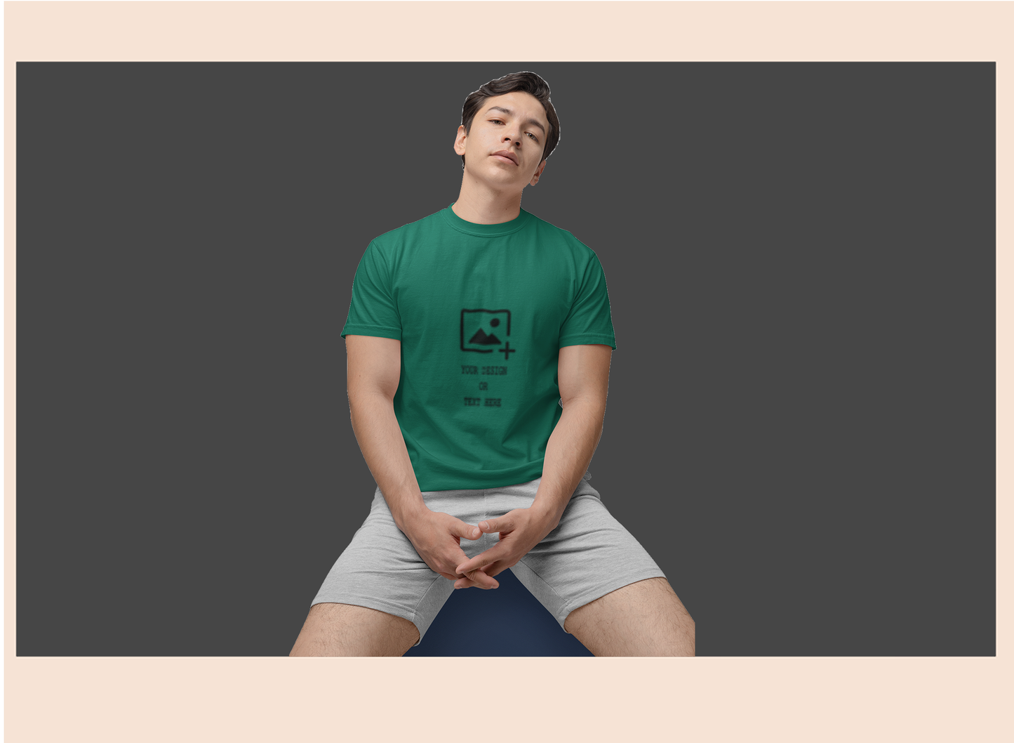Person wearing a green t-shirt with a graphic design on a dark background