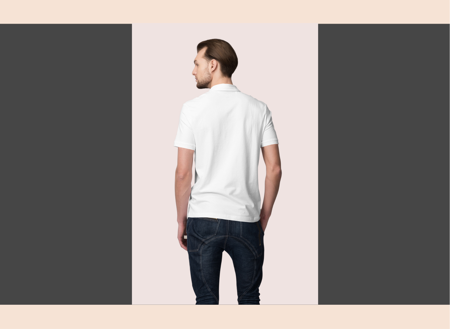 Man wearing a white t-shirt and dark jeans on a light pink background