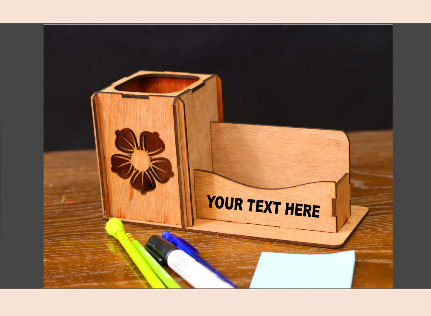 Wooden pen holder with business card stand on a wooden surface with stationery items.