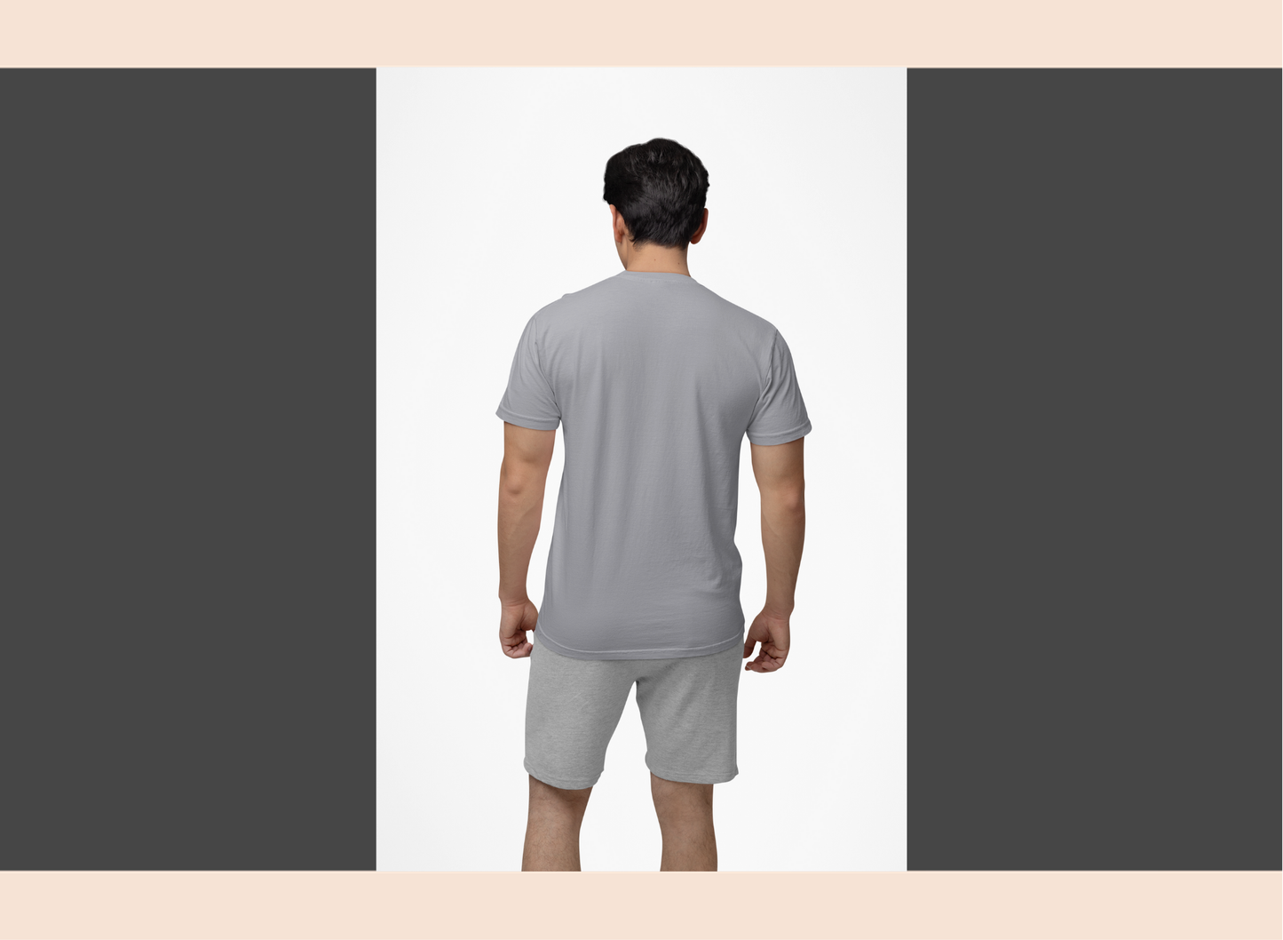 Man wearing a gray t-shirt and shorts set on a plain background