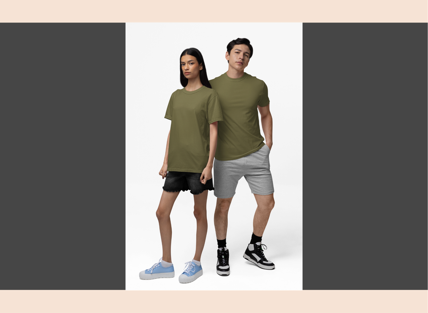 Two people wearing green t-shirts and gray shorts on a white background