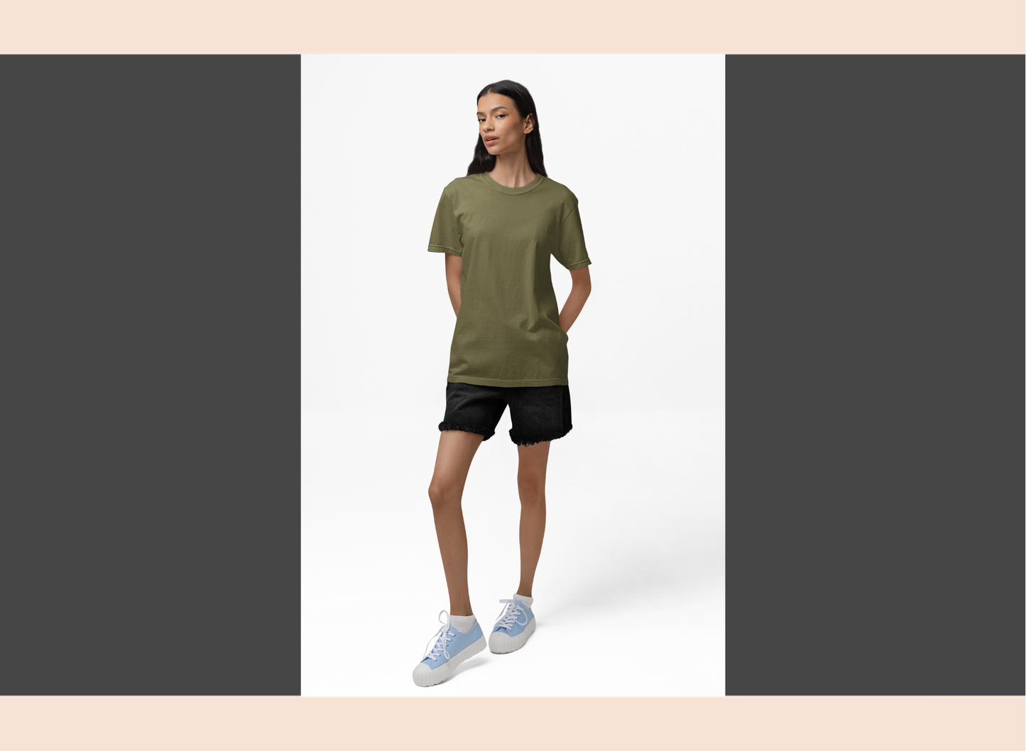Woman wearing a green t-shirt and black shorts on a white background