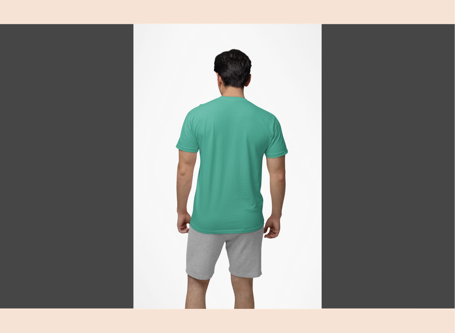 Man wearing a green t-shirt and gray shorts on a plain background