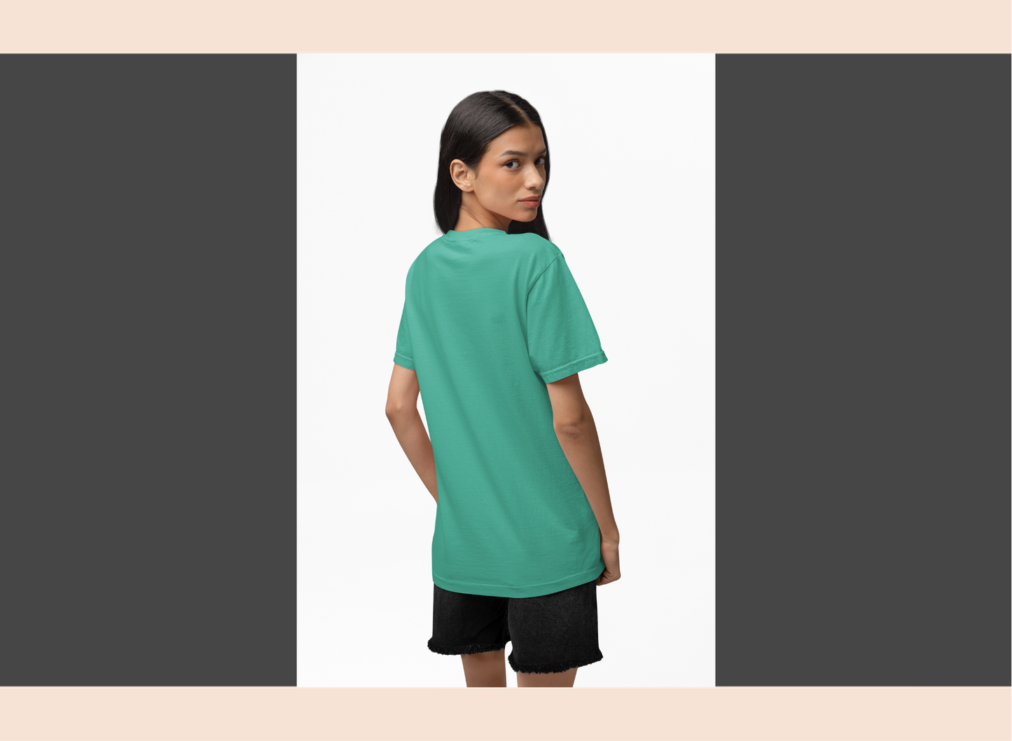 Woman wearing a teal t-shirt and black shorts on a white background