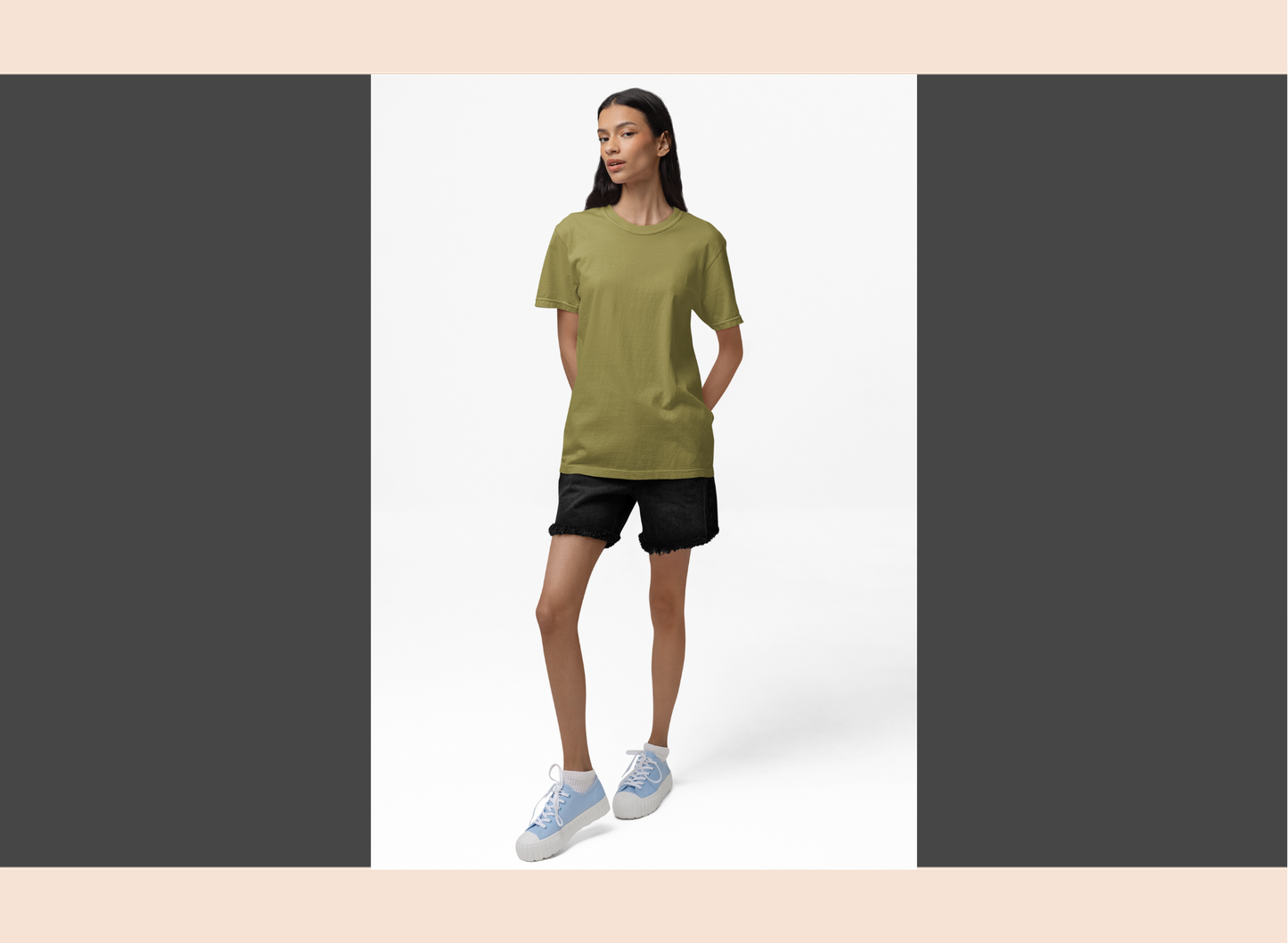 Person wearing a green t-shirt and black shorts on a white background