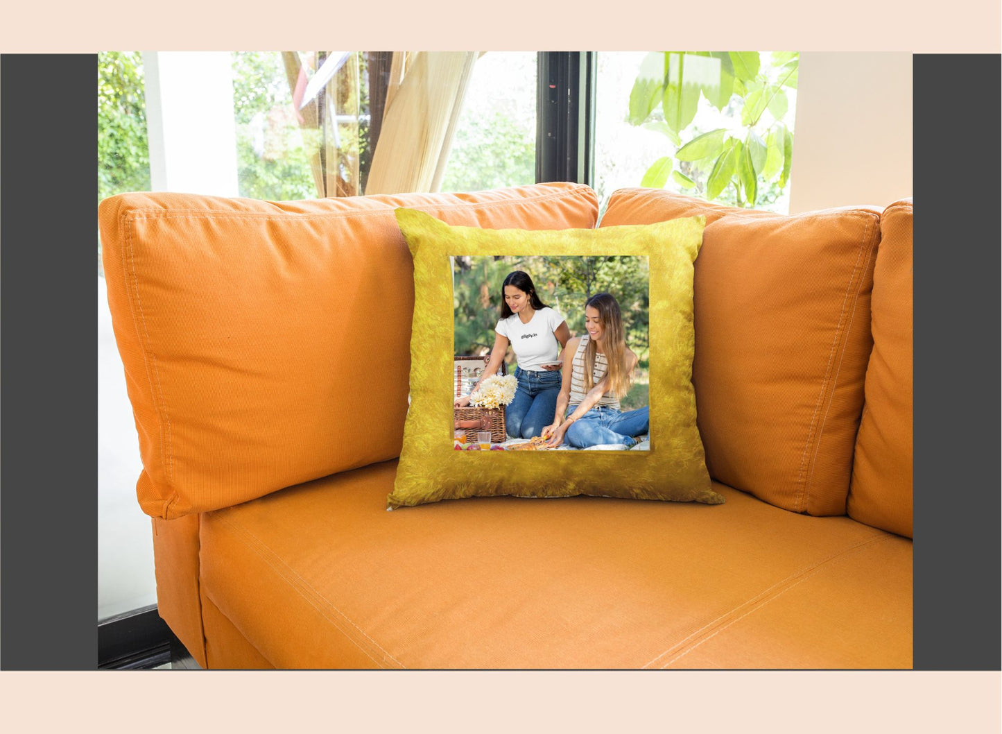 Orange sofa with a green pillow featuring two women on it, in a room with a window and plants.