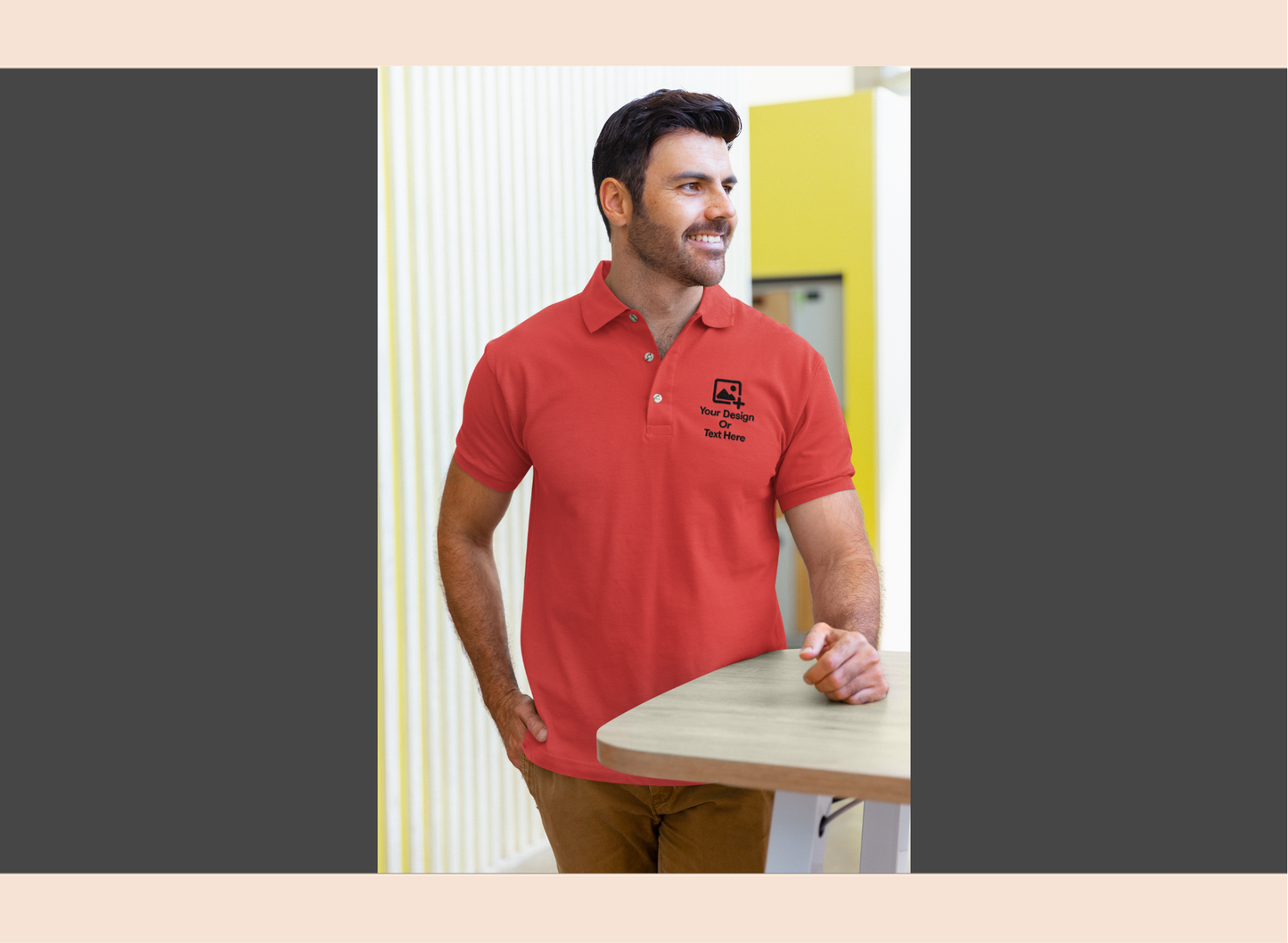 Man wearing a navy blue polo shirt with a logo, standing indoors.