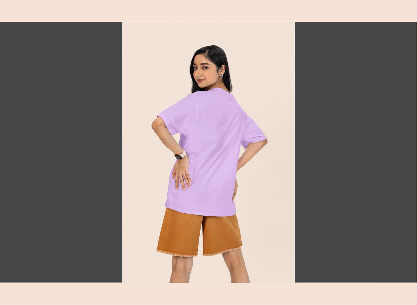 Woman wearing a light purple top and brown shorts on a beige background