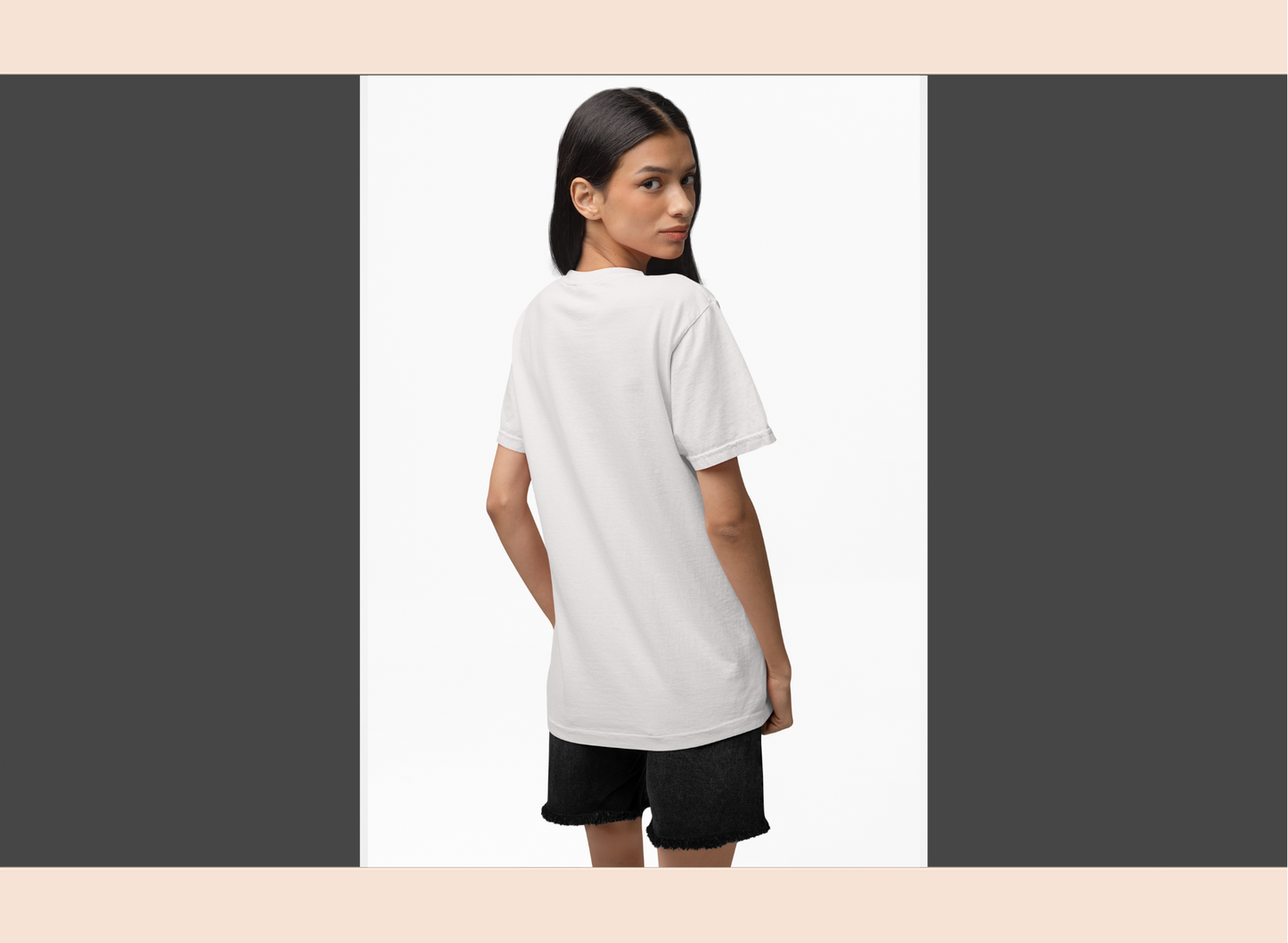 Woman wearing a white t-shirt and black shorts on a plain background