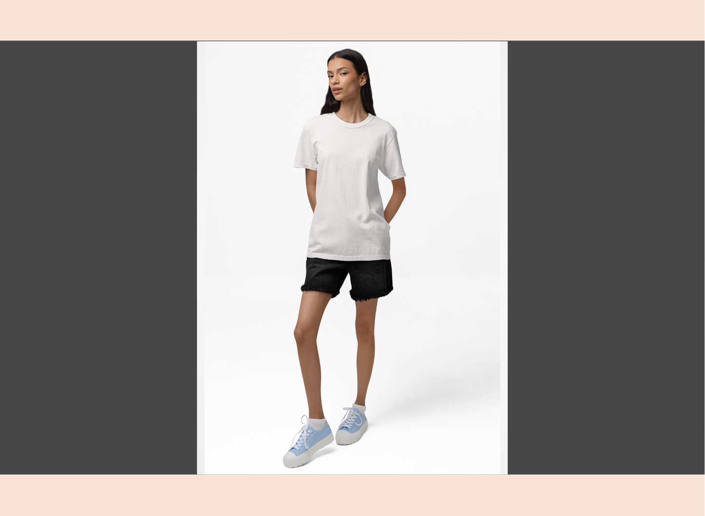 Woman wearing a white t-shirt and black shorts on a white background