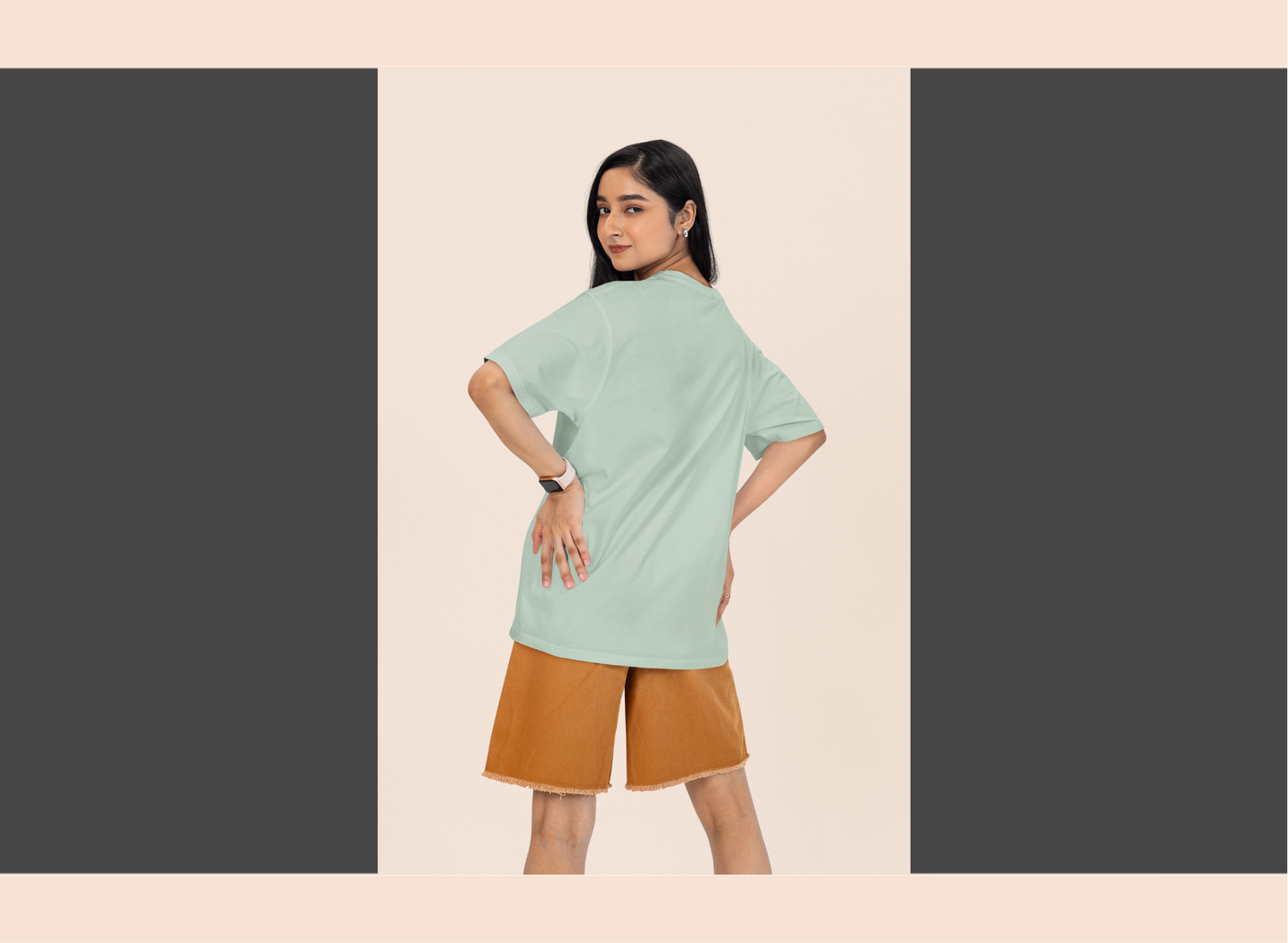Woman wearing a light green top and brown shorts on a beige background