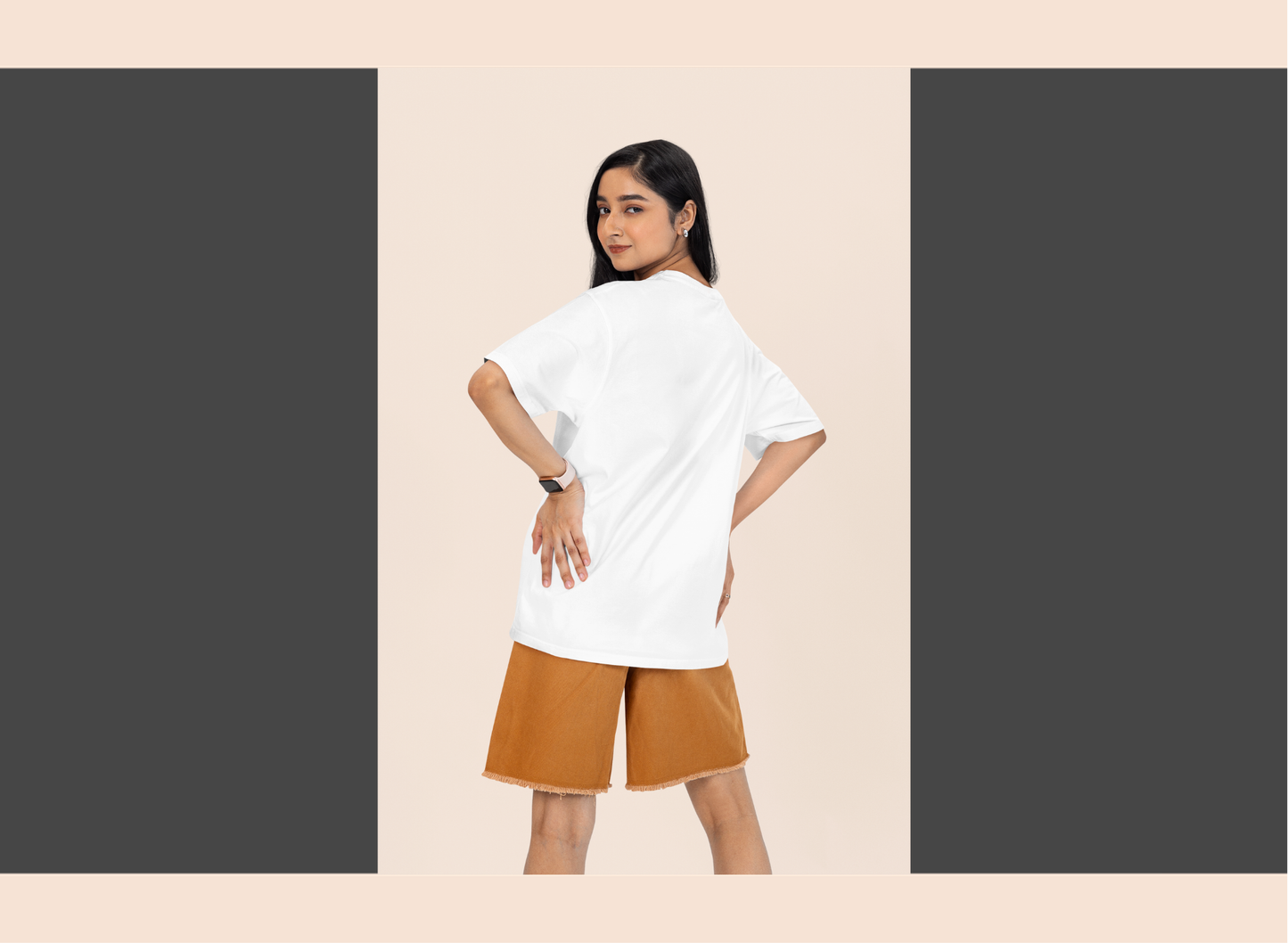Woman wearing a white t-shirt and brown shorts on a beige background