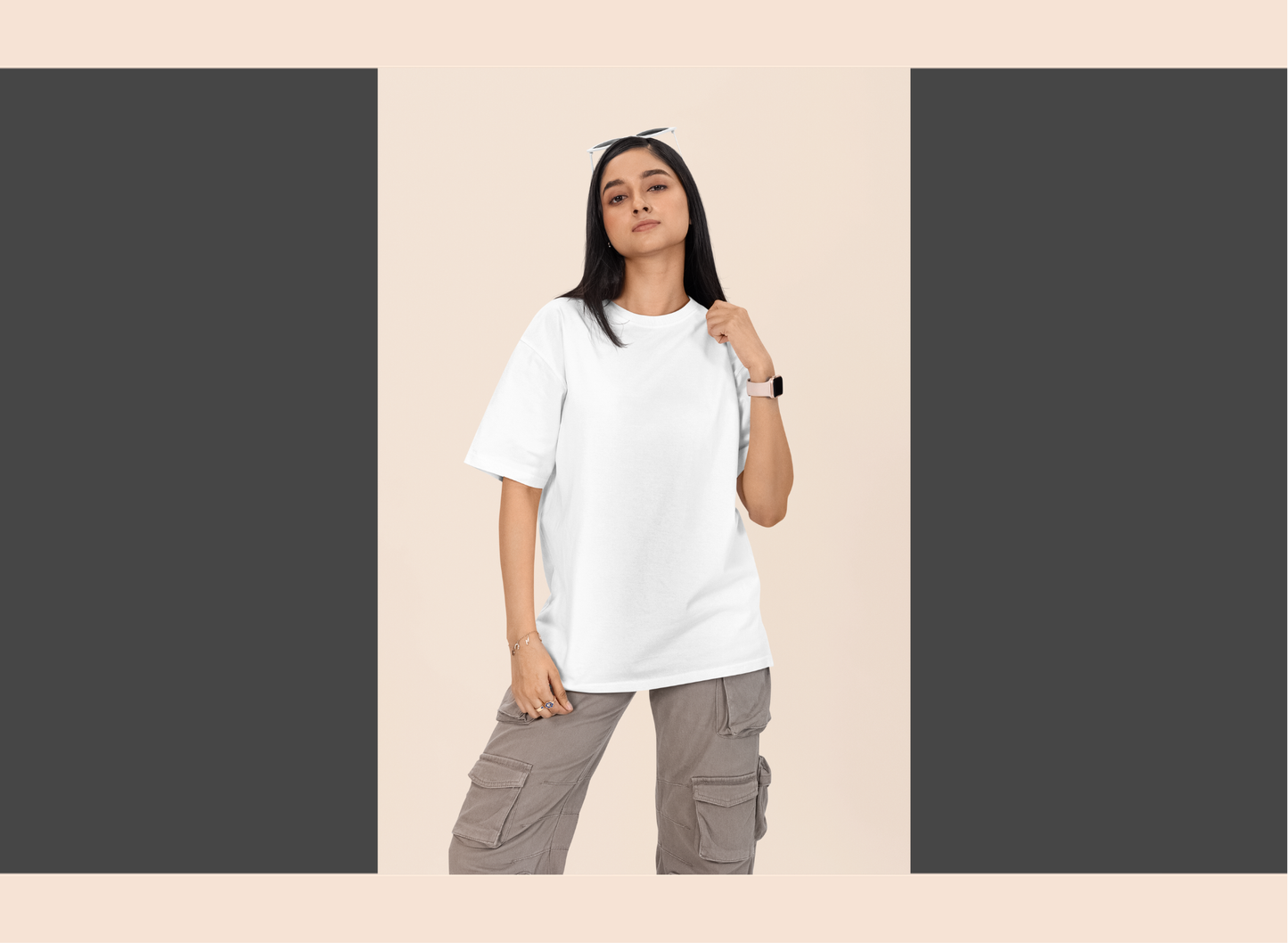 Person wearing a white t-shirt and gray cargo pants on a beige background