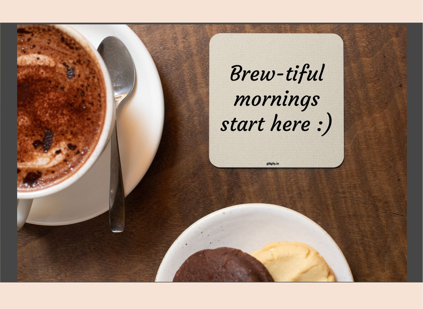 Cup of coffee with a spoon and dessert on a wooden table, coaster with 'Brew-tiful mornings start here :)' text.