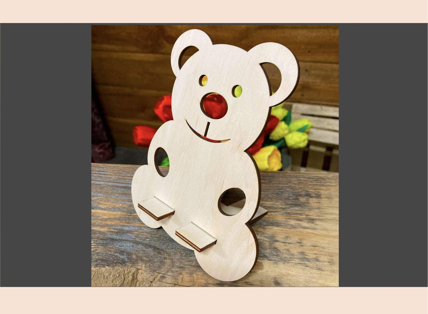Wooden teddy bear decoration on a wooden surface with a blurred background