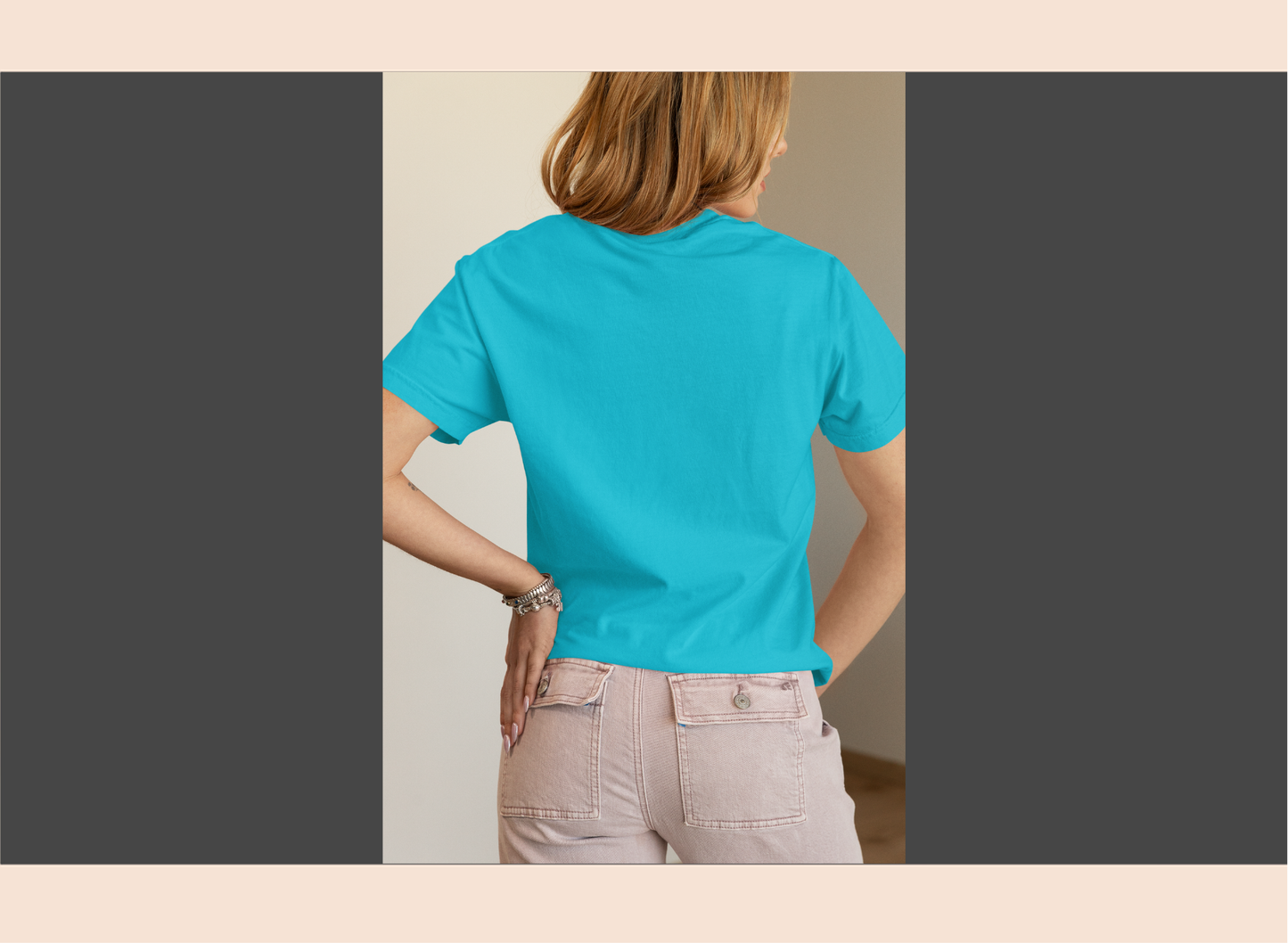 Person wearing a bright blue t-shirt with a plain background