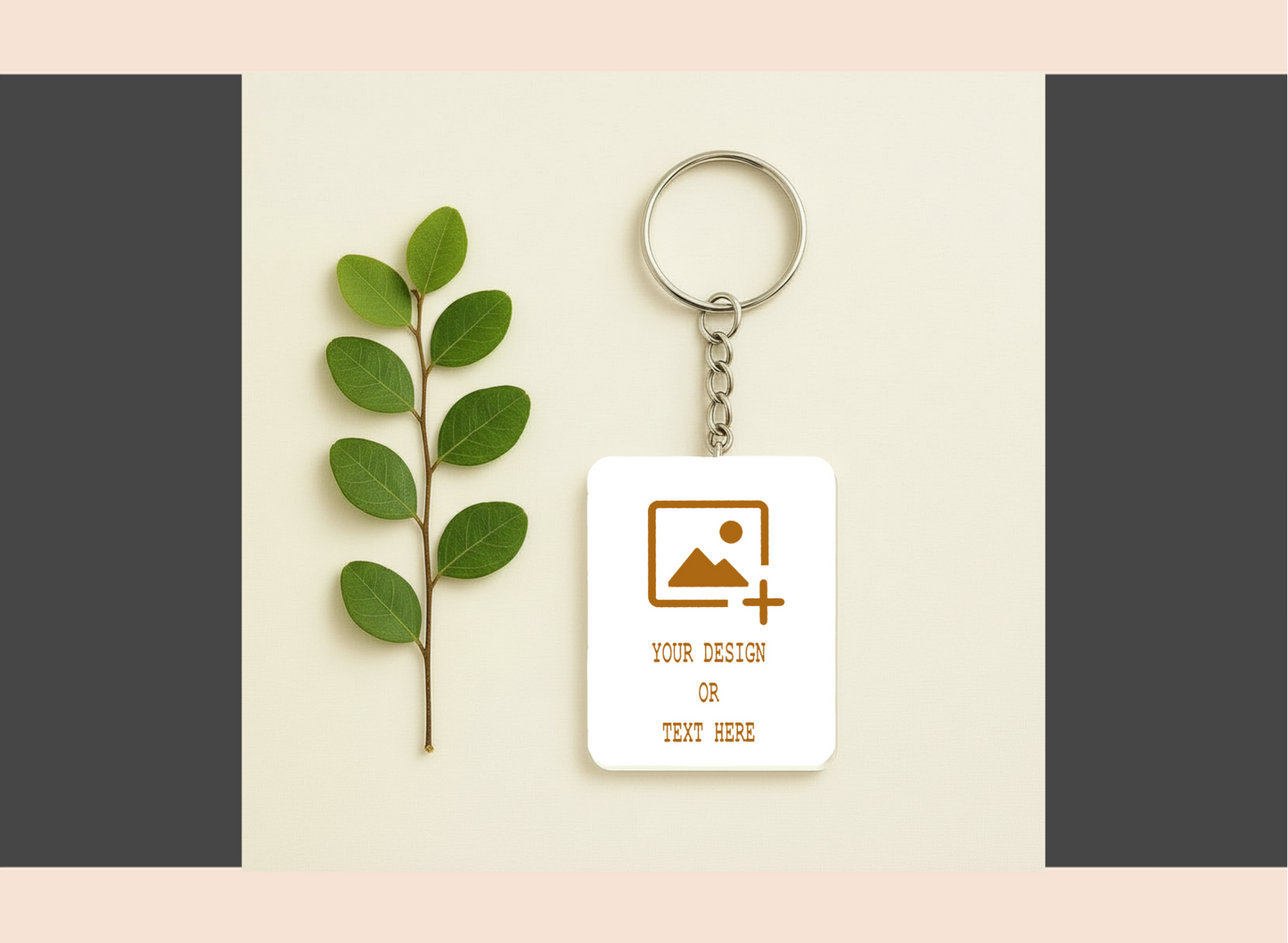 Keychain with customizable design area next to a leaf on a light background