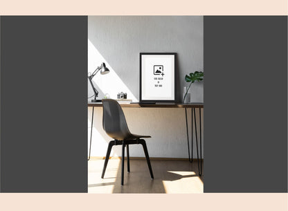 Modern office desk with chair, lamp, and framed picture on a gray background