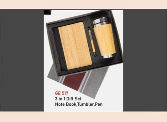 3-in-1 gift set with a notebook, tumbler, and pen in a black box on a gray background.