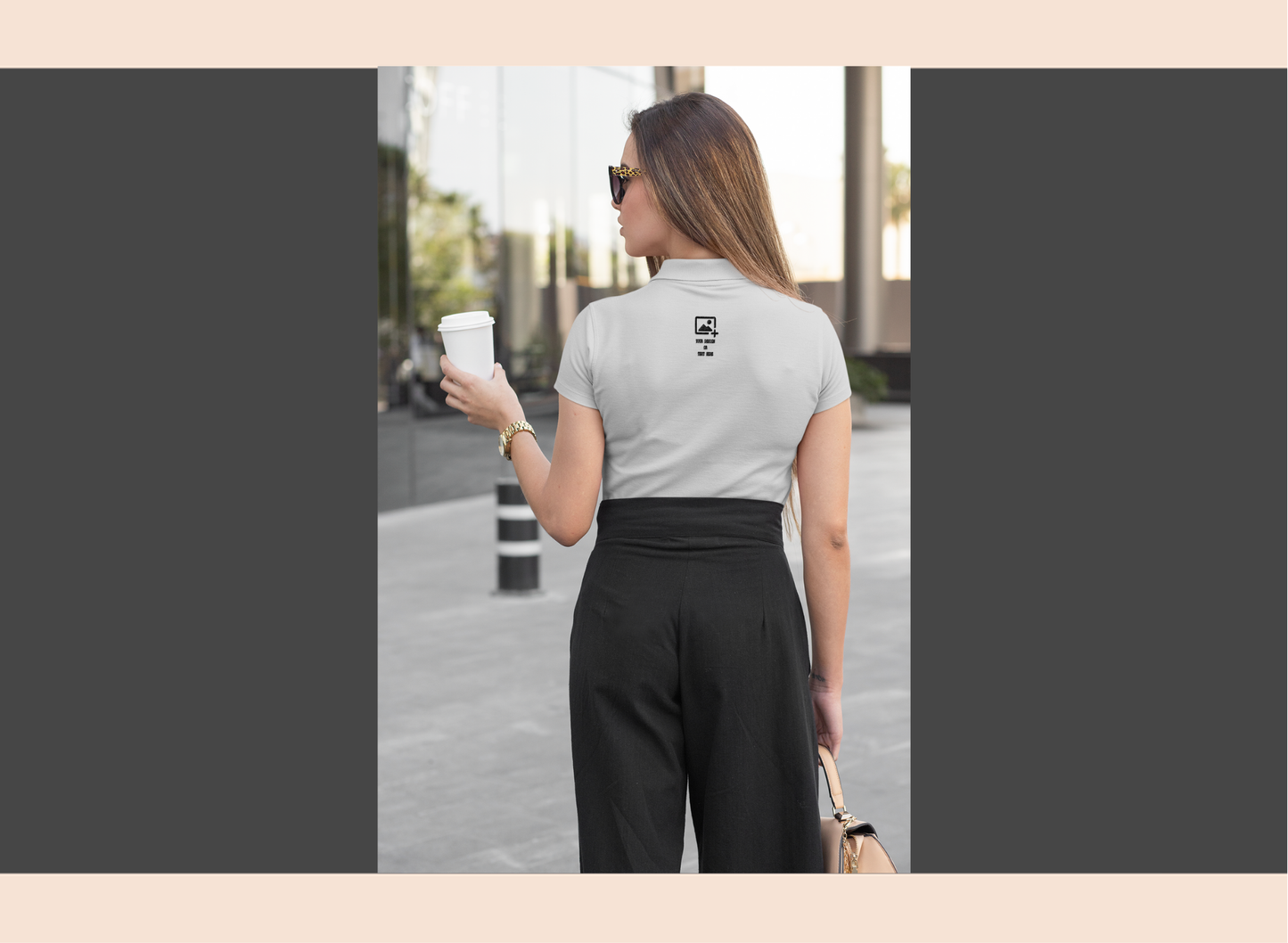 Woman holding a coffee cup on a city street