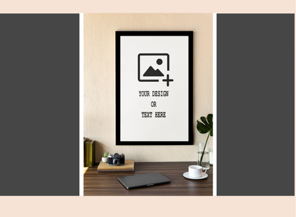 Framed poster mockup on a wall with a minimal desk setup.