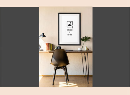 Modern office desk with a chair and framed poster on a neutral wall.