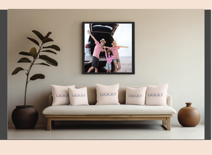 Sofa with 'GILKINS' cushions, framed family photo above, and decorative plants on either side.