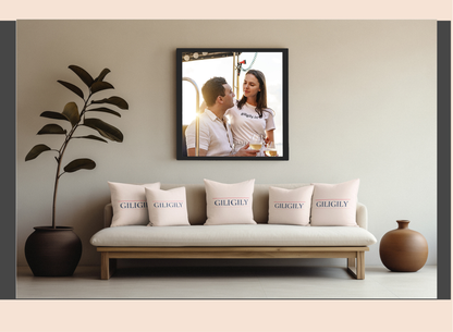 Sofa with 'Giglioli' pillows, decorative plant, and framed photo of a couple on the wall.