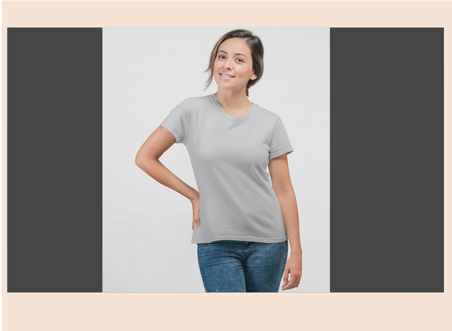 Woman wearing a gray t-shirt and blue jeans on a light gray background