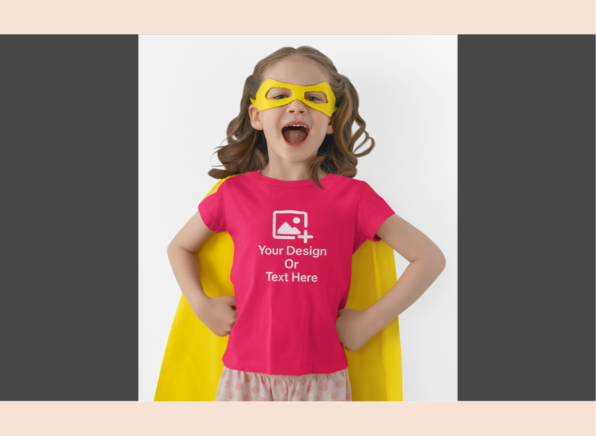 Child wearing a pink t-shirt with customizable design area, yellow cape, and mask on a white background