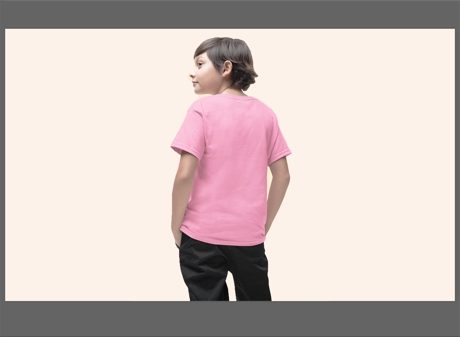 Child wearing a pink t-shirt on a plain background