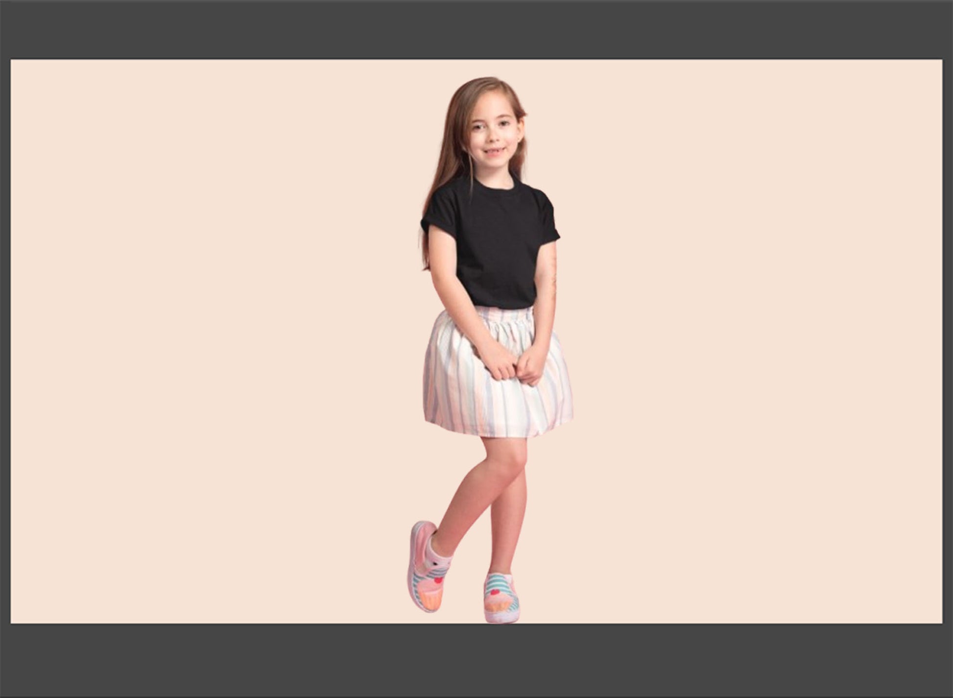 Young girl wearing a black top and white skirt on a beige background