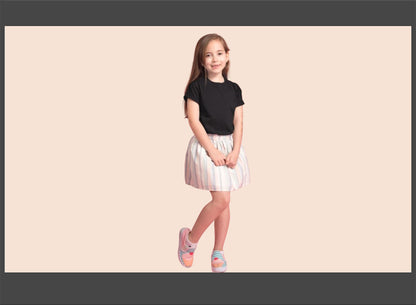 Young girl wearing a black top and white skirt on a beige background