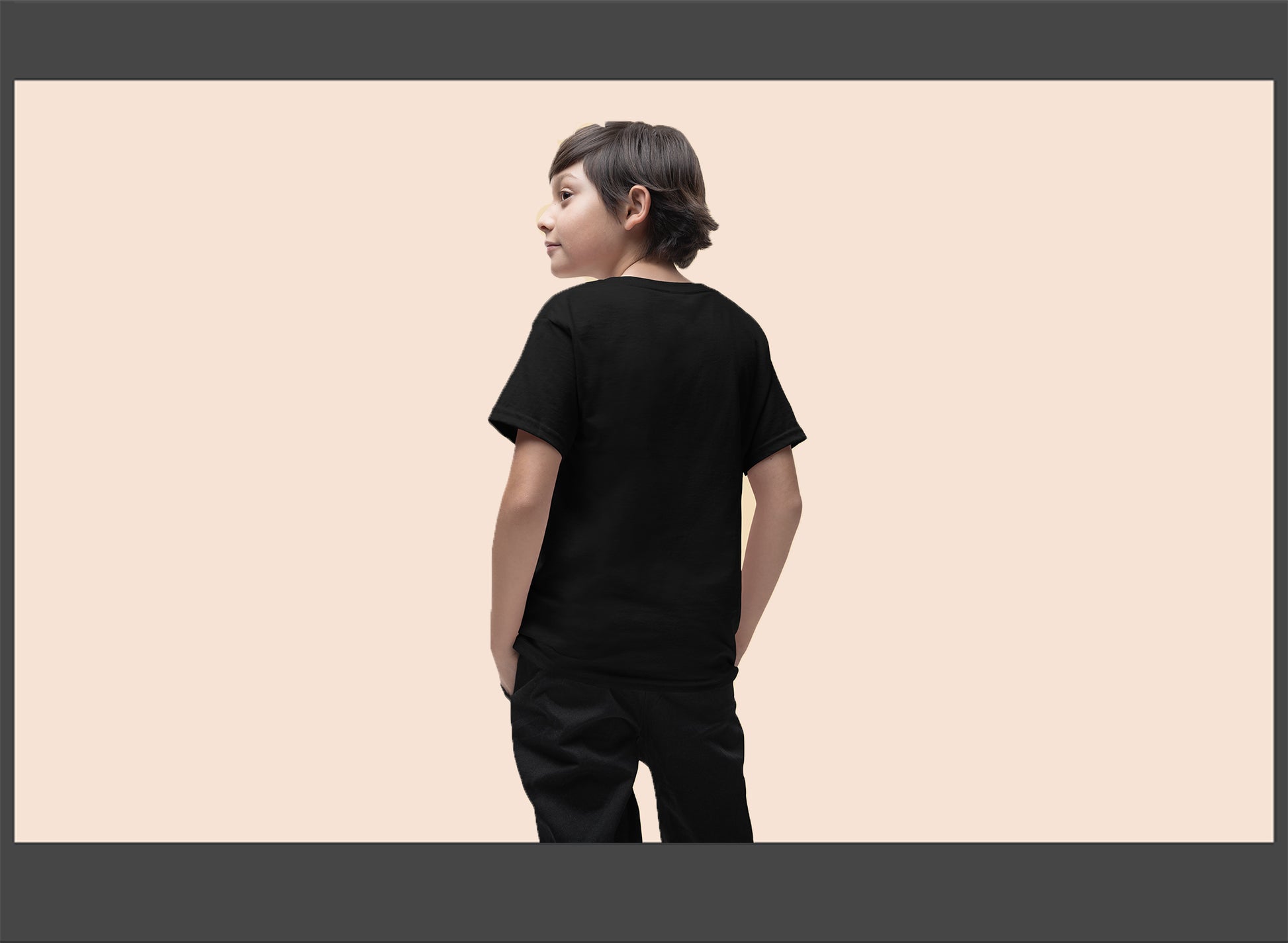 Person wearing a black t-shirt and pants on a beige background
