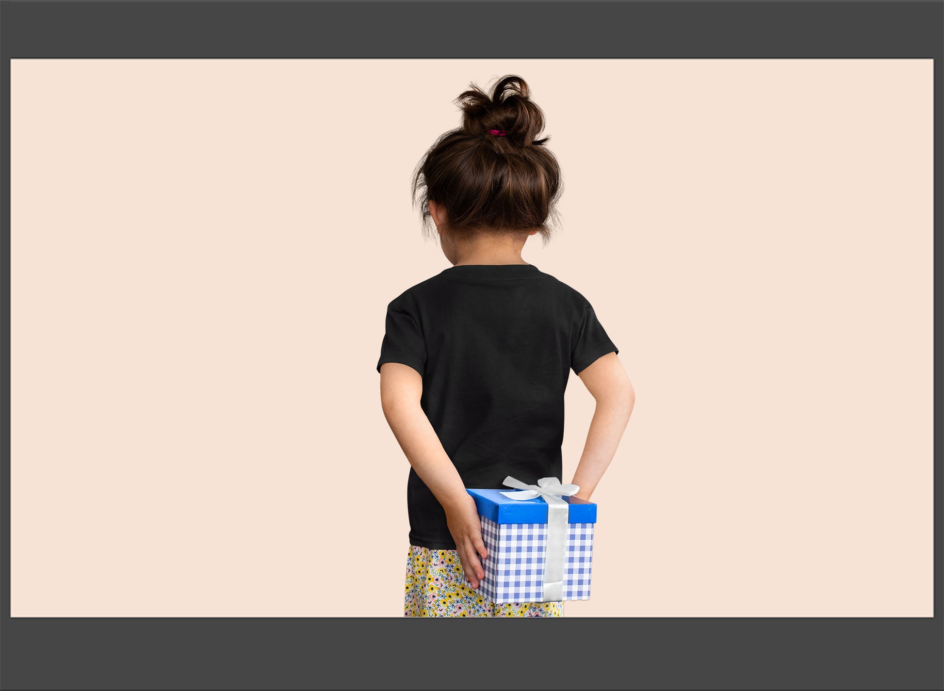 Child holding a gift box with a plain background