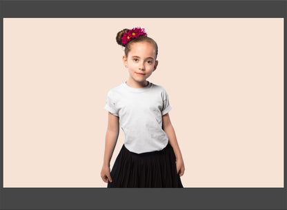 Young girl wearing a white t-shirt and black skirt with a pink background