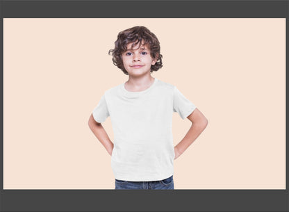 Child wearing a plain white t-shirt against a beige background