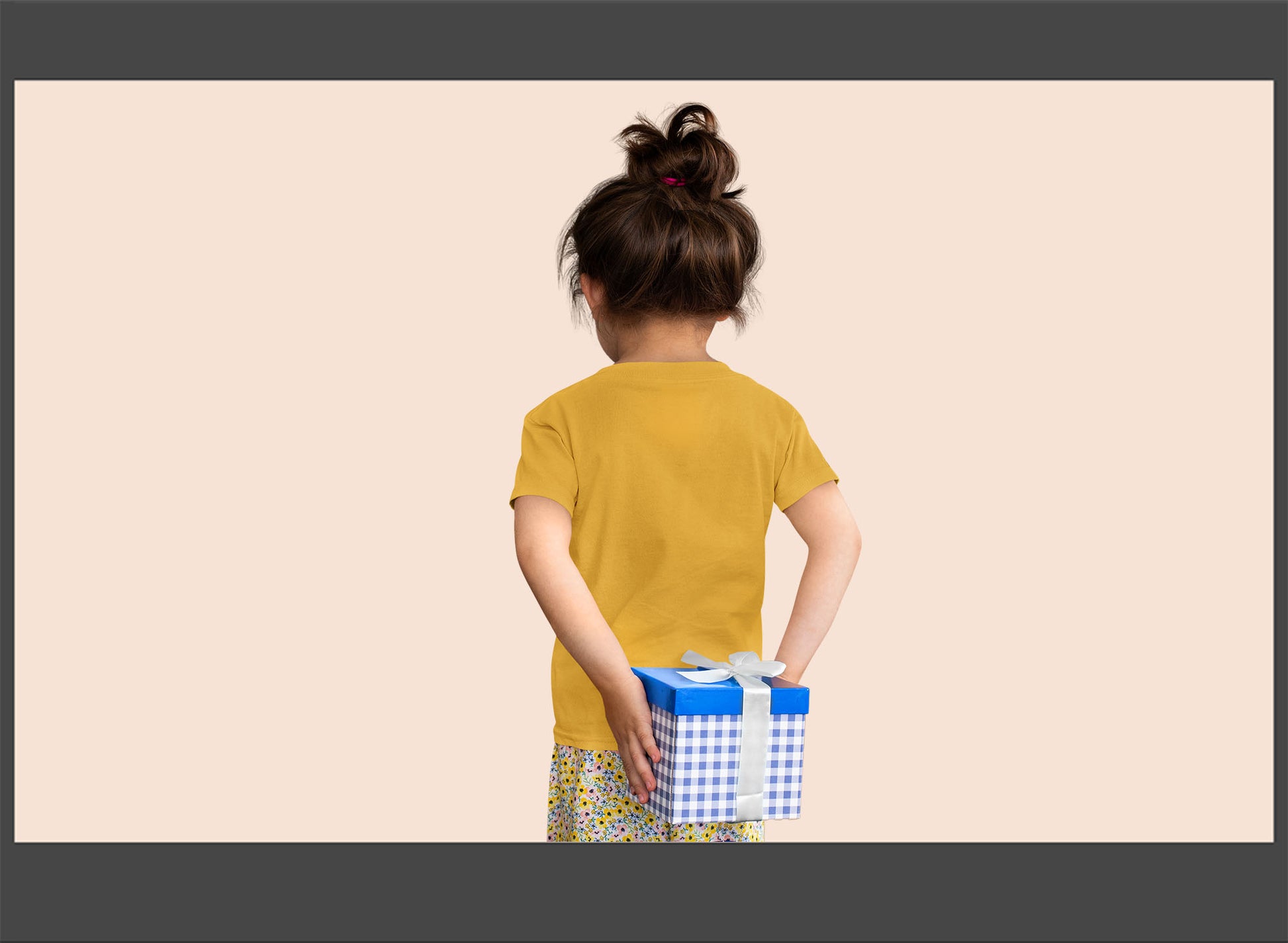 Child holding a gift box with a plain background