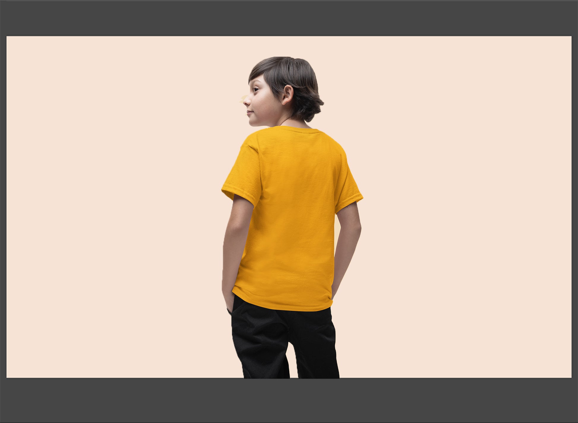 Child wearing a yellow t-shirt on a beige background