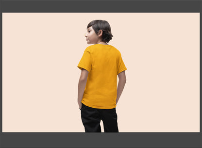 Child wearing a yellow t-shirt on a beige background