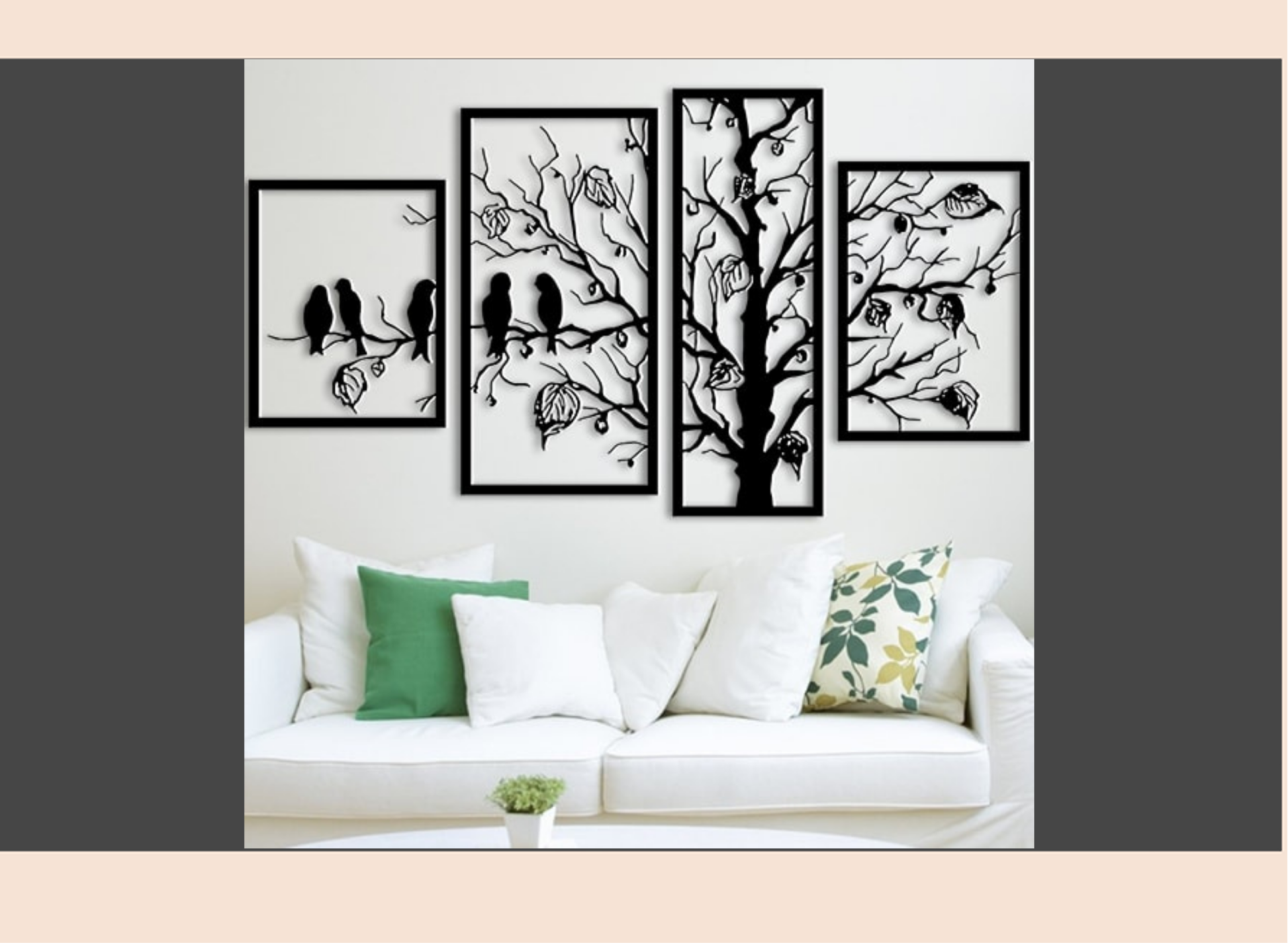 Set of four black and white wall art pieces on a wall above a white sofa with decorative pillows.