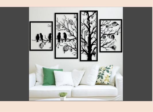 Set of four black and white wall art pieces on a wall above a white sofa with decorative pillows.