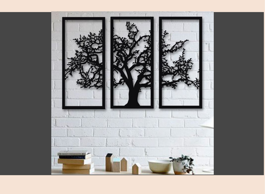Three framed black tree sculptures on a white brick wall with decorative items below.